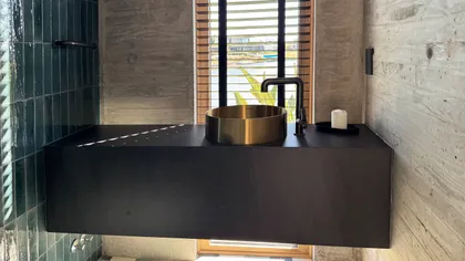 Baño moderno con bacha dorada y vanitory flotante negro — proyecto CASA MHN, por Hermann Arquitectos, en Nordelta